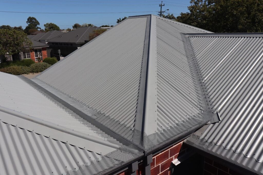 Grey corrugated roof with gutter guards installed