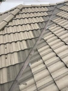 Grey tiled roof valley with mesh gutter guard